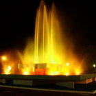 Nighttime Fountain Glowing with Golden Lights and Starry Sky