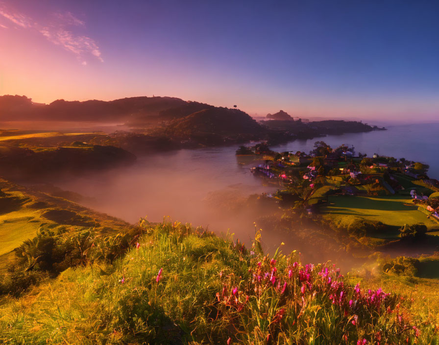 Misty sunrise over vibrant coastal landscape