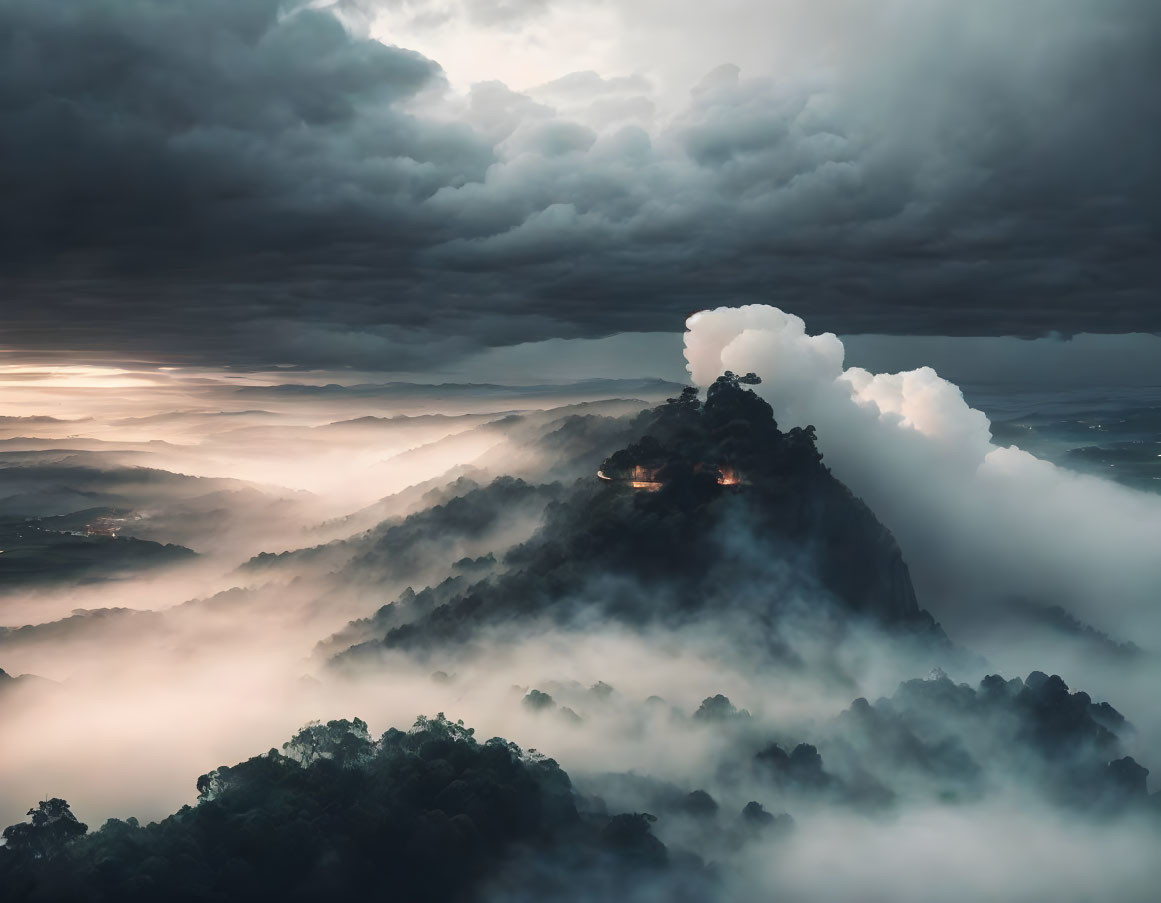 Misty mountain with lit structure in stormy sky