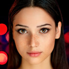 Young girl with big brown eyes and slight smile in close-up portrait.