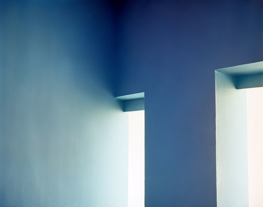 Minimalist photo of smooth walls, white columns, and blue gradient background