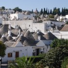 European-style town with terracotta roofs and stone bridges by a river