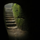 Golden Light Illuminates Mystical Cave Stairs Reflecting Tranquil Water