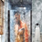 Man standing under streaming water in modern bathroom