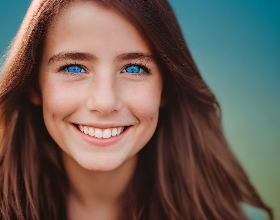 Smiling woman with blue eyes and brown hair in close-up portrait