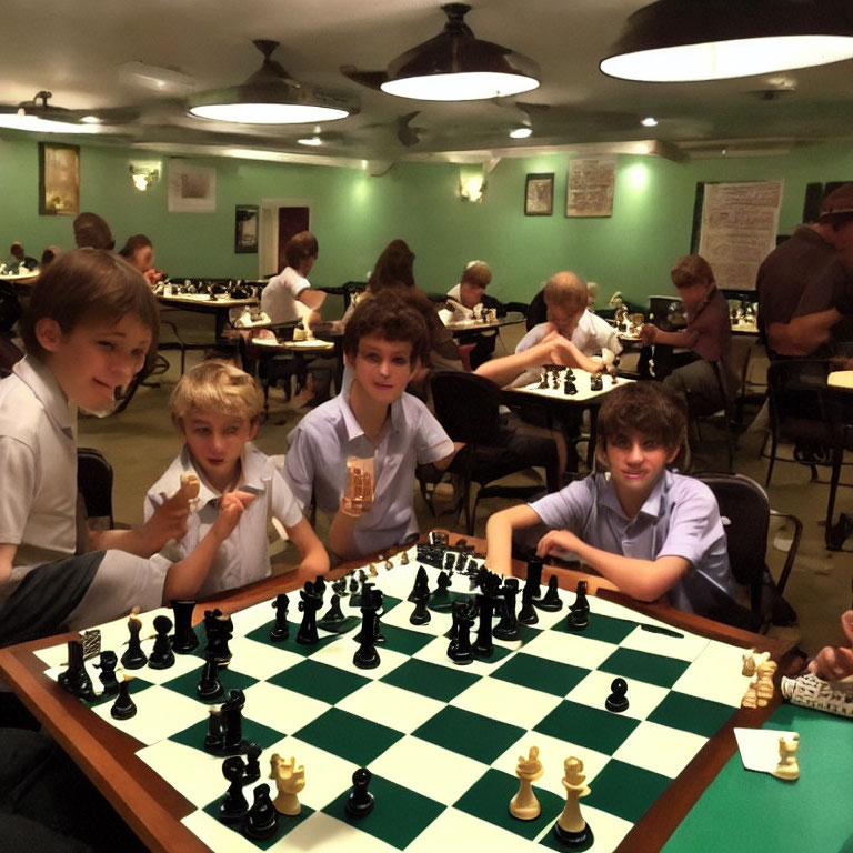 Crowded chess club with young players in focused games