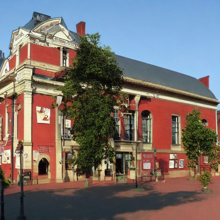 Classical red brick building with mansard roof on cobblestone plaza