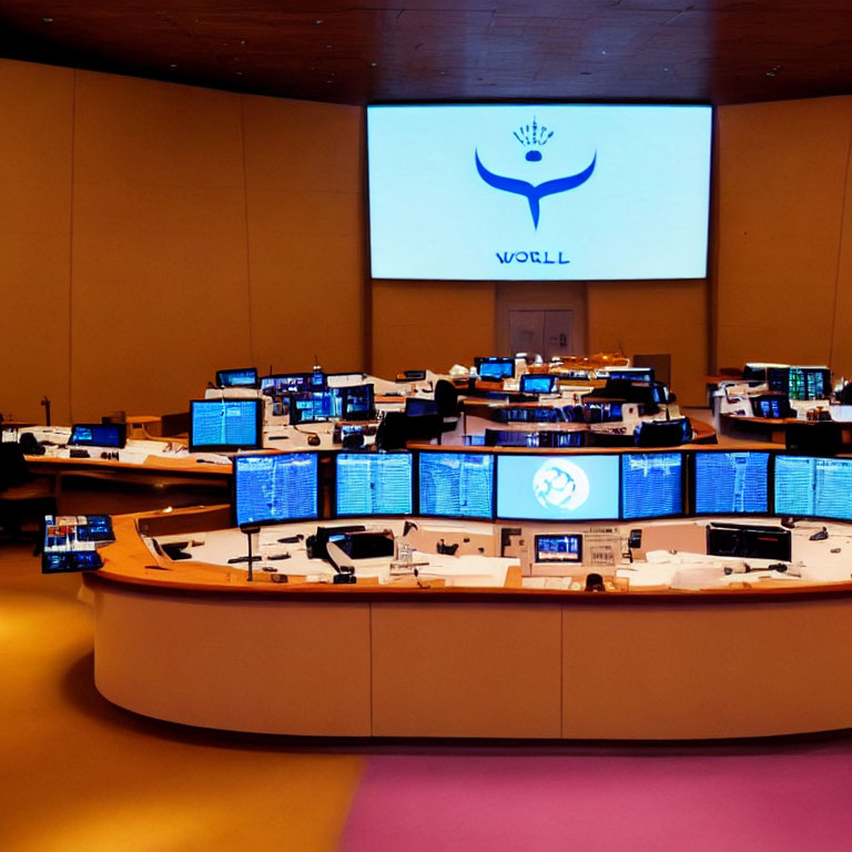 Modern Control Room with Multiple Workstations and Large Wall Screens Displaying Logos and Information