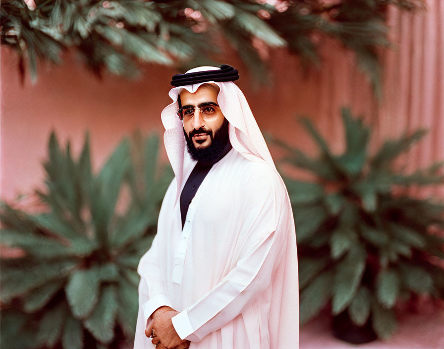 Traditional Arabic Attire - Man in White Thobe and Black Agal Against Pink Wall