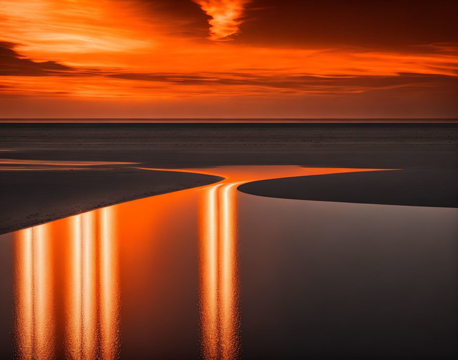 Intense Orange Sunset Reflecting in Tranquil Beach Water