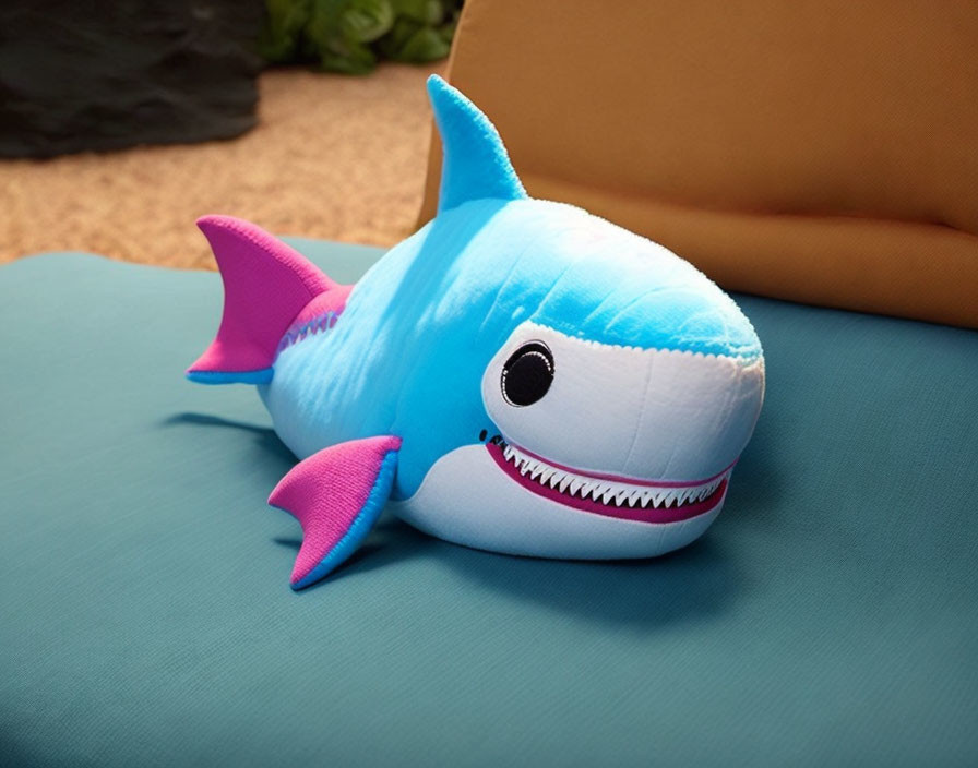 Colorful Plush Toy Shark with Blue and Pink Features on Blue Surface