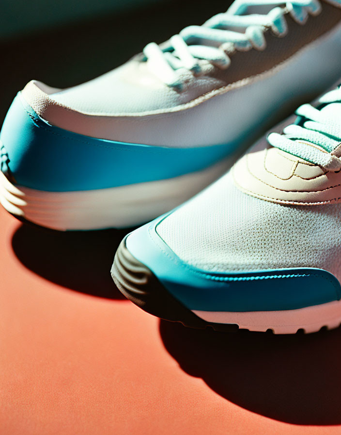 White and Blue Sneakers on Red Surface with Soft Light