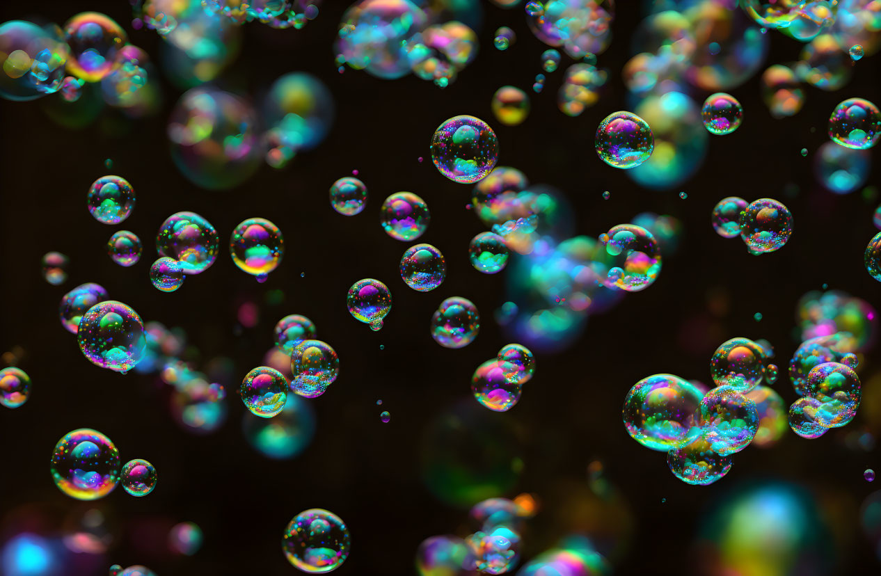 Vibrant soap bubbles with iridescent swirls on dark backdrop