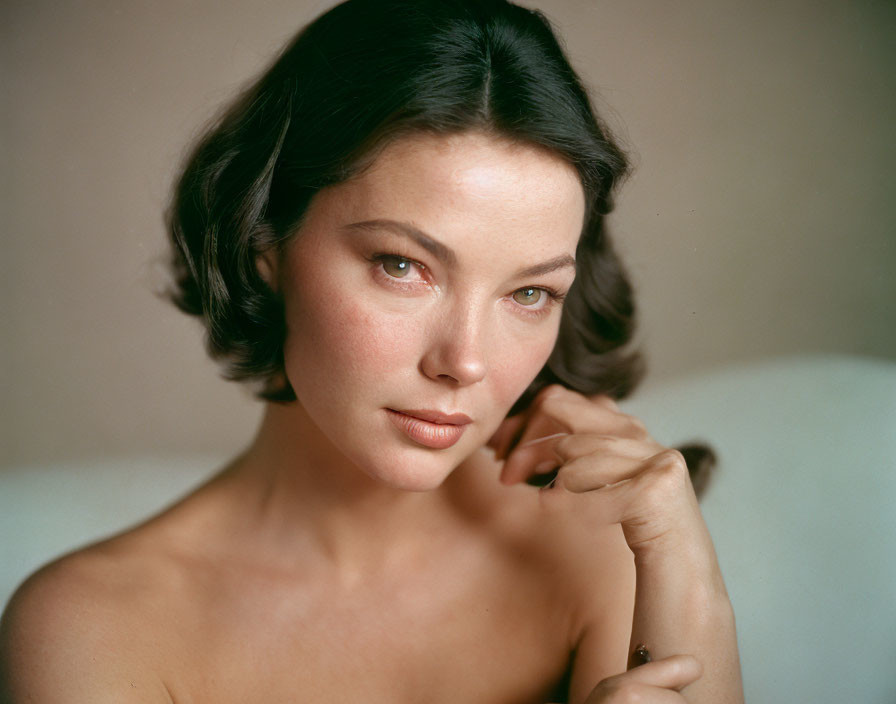 Portrait of woman with short dark hair and fair skin gazing at camera