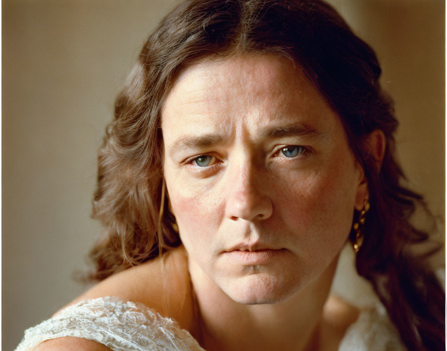 Serious woman portrait with brown hair and white lace top