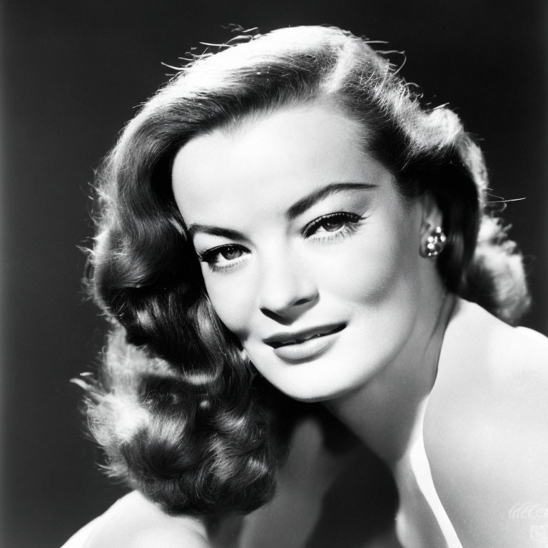 Monochrome portrait of woman with wavy hair and subtle smile