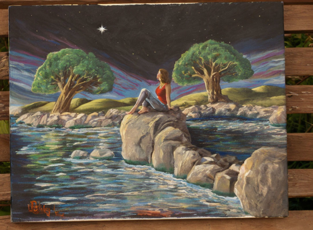 Person sitting on rock by river under starlit sky with colorful trees.