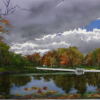 Scenic autumn landscape with pond, fall trees, path, cloudy sky