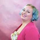 Illustrated portrait of woman with blue curly hair and red lips against pastel backdrop