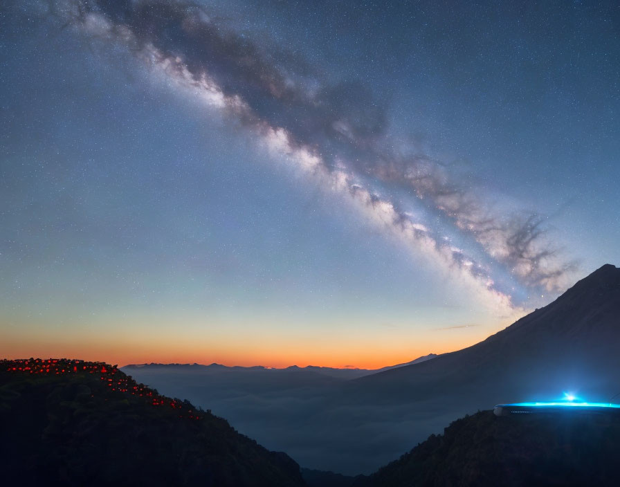 Panoramic night sky with Milky Way over mountain settlements