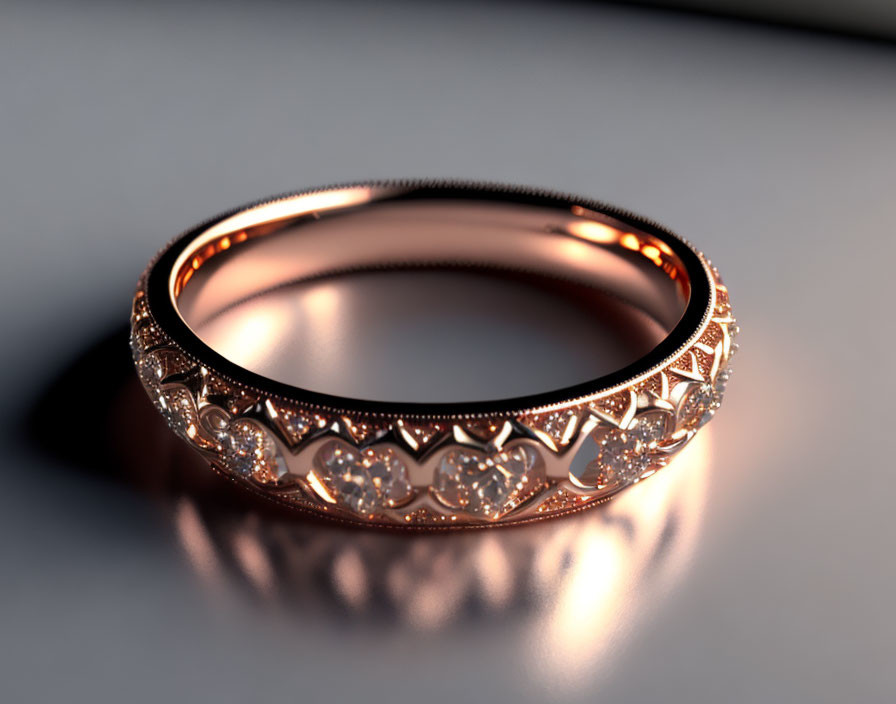 Rose Gold Ring with Filigree, Diamonds, and Patterned Band on Reflective Surface