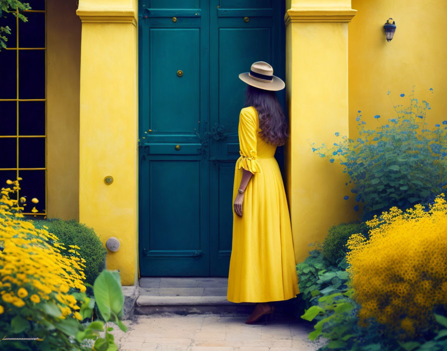 Woman in Yellow Dress and Hat by Green Door with Yellow Flowers