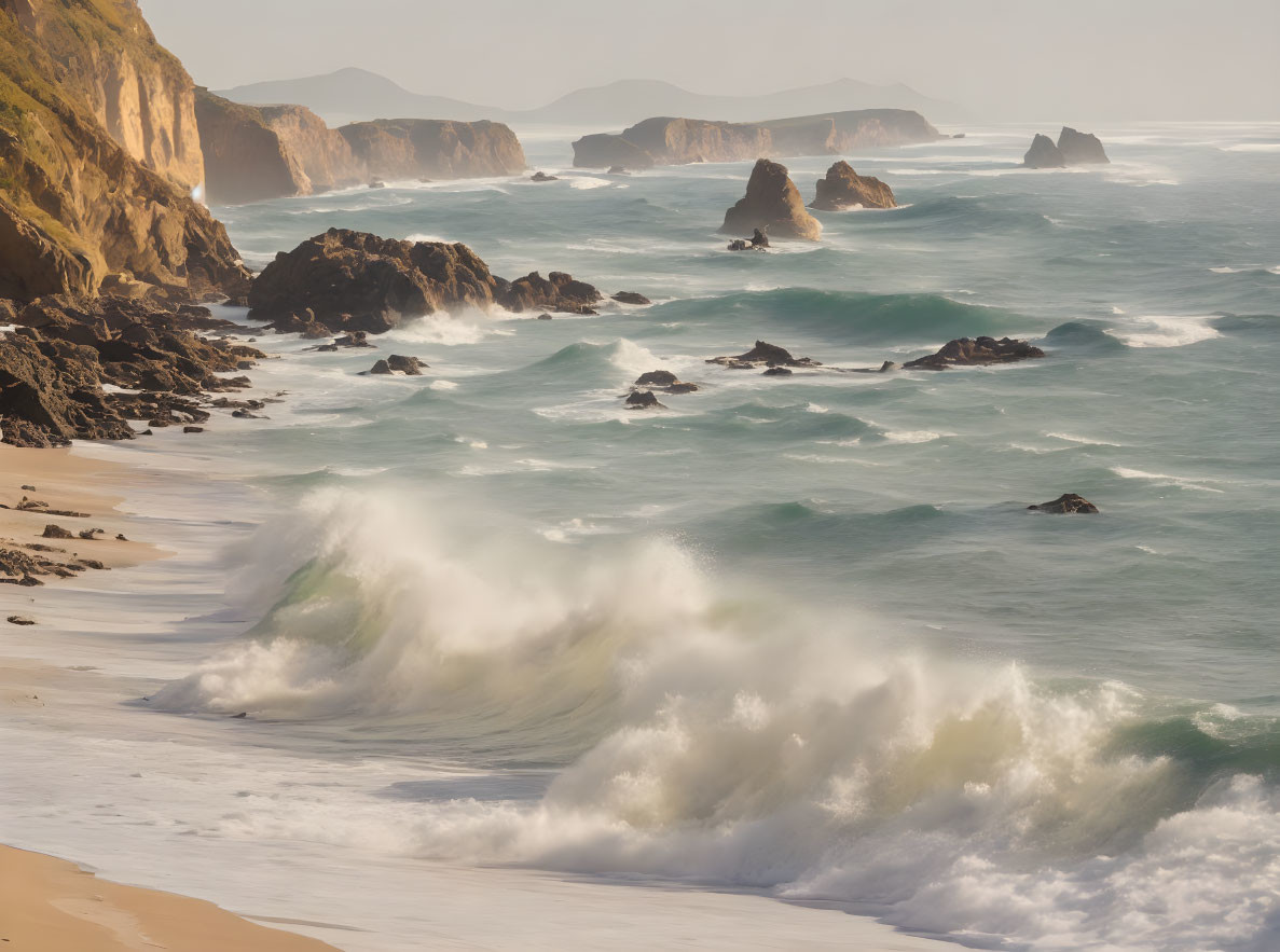 Rocky cliffs and crashing waves in misty beach scene