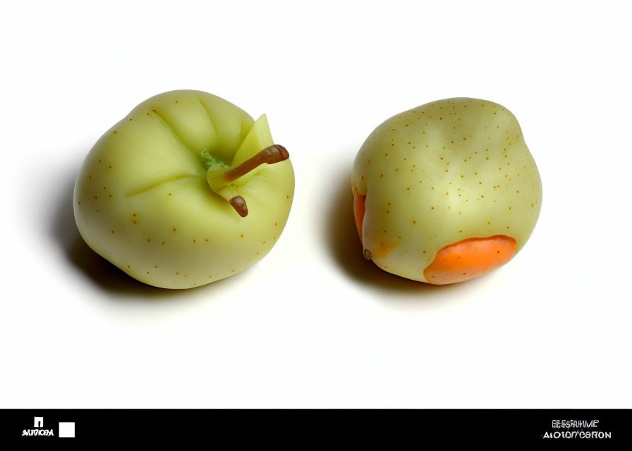 Stylized apples resembling human buttocks on white background