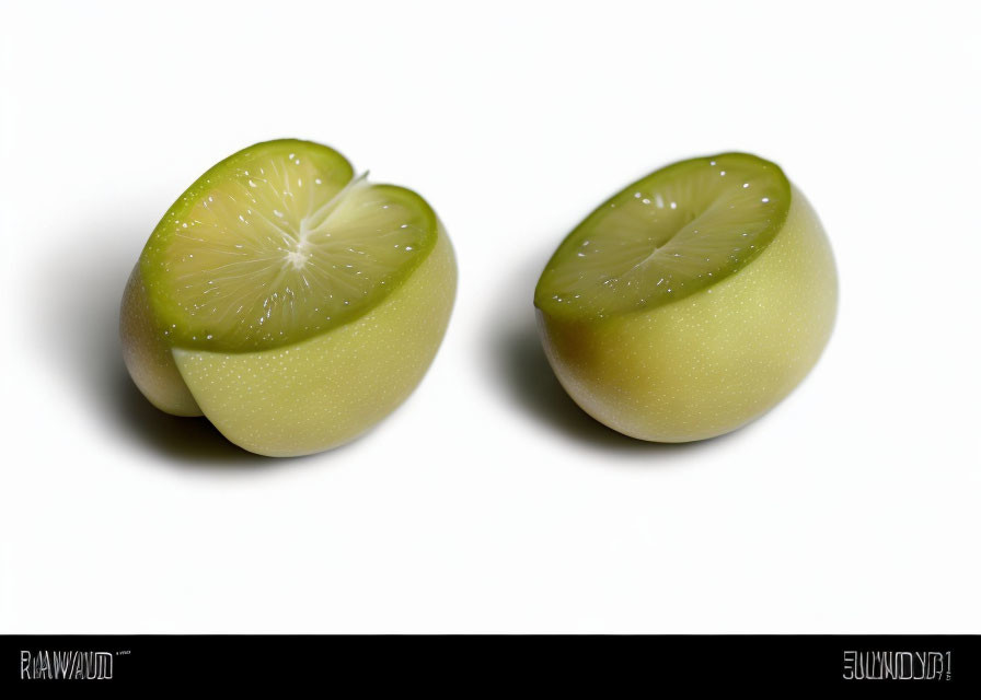 Halved Greenish-Yellow Citrus Fruit on White Background