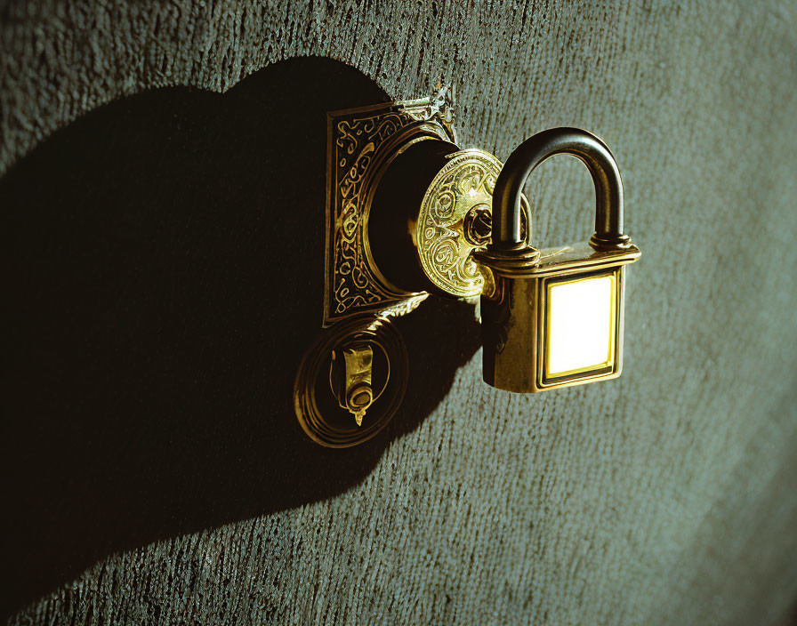Golden keyhole with padlock under dramatic lighting on textured wall