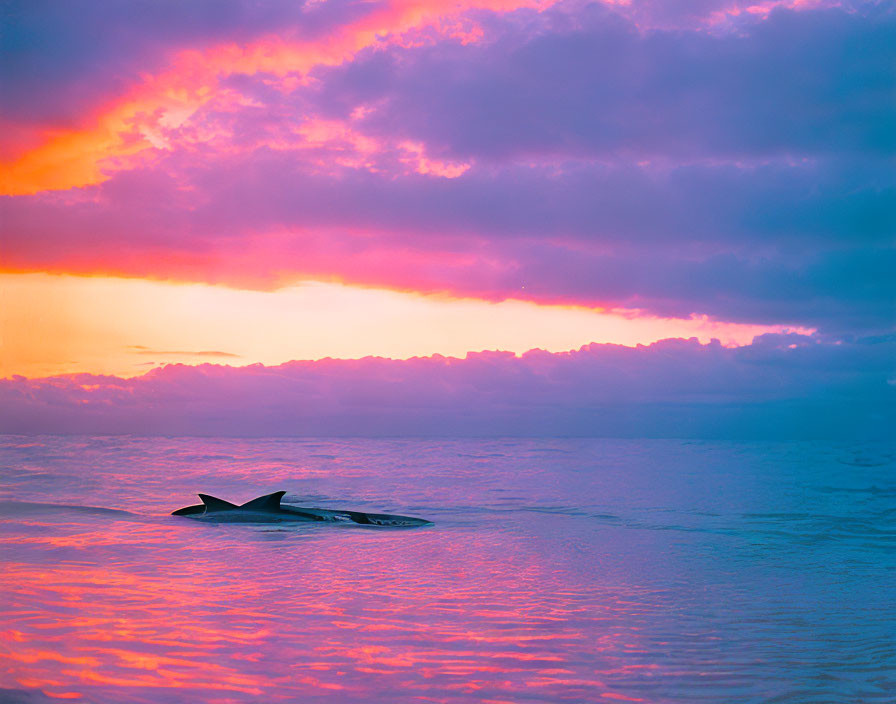 Capsized Boat Floating on Tranquil Sea at Sunset with Pink and Purple Clouds