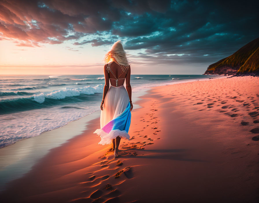 Blonde woman in white and blue dress strolls on beach at sunset