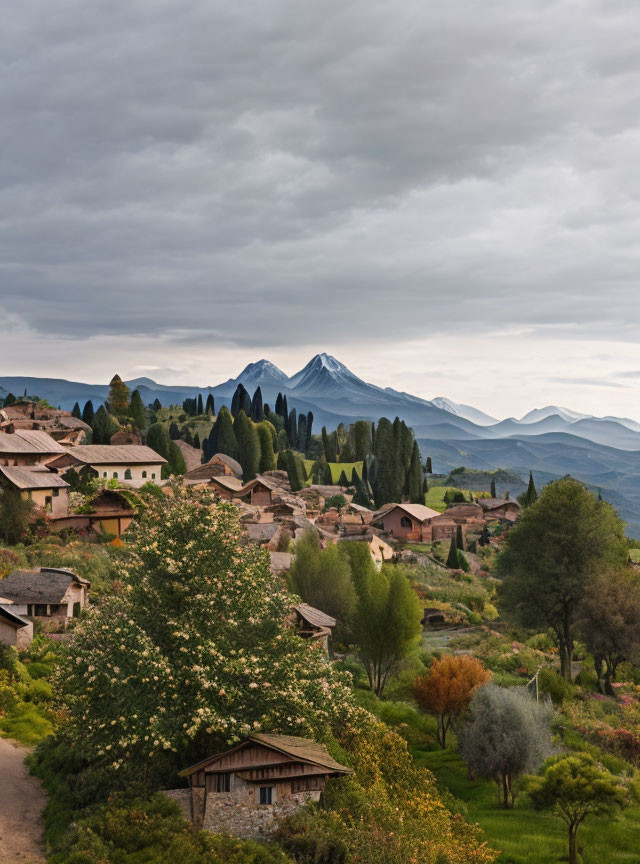 Scenic rustic village with terracotta roofs and snowy mountains