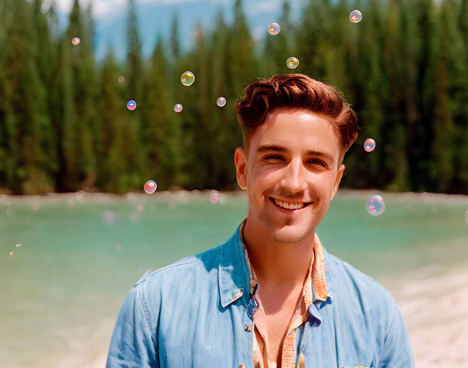 Man in Blue Shirt Smiling Outdoors with Soap Bubbles and Nature Background