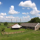 Scenic village with quaint houses, gardens, river, and birds