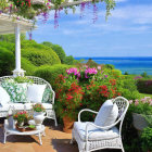 Ocean view with flower-fringed patio and sailing boats in the distance