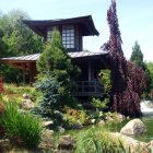 Traditional Japanese Garden with Pagoda, Colorful Flowers, Trimmed Bushes, and Tranquil Pond