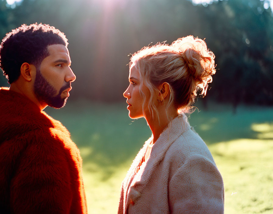 Two people in profile at sunset with lush green background