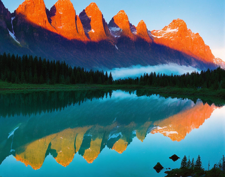 Mountain Peaks Illuminated by Sunrise Reflecting in Serene Lake