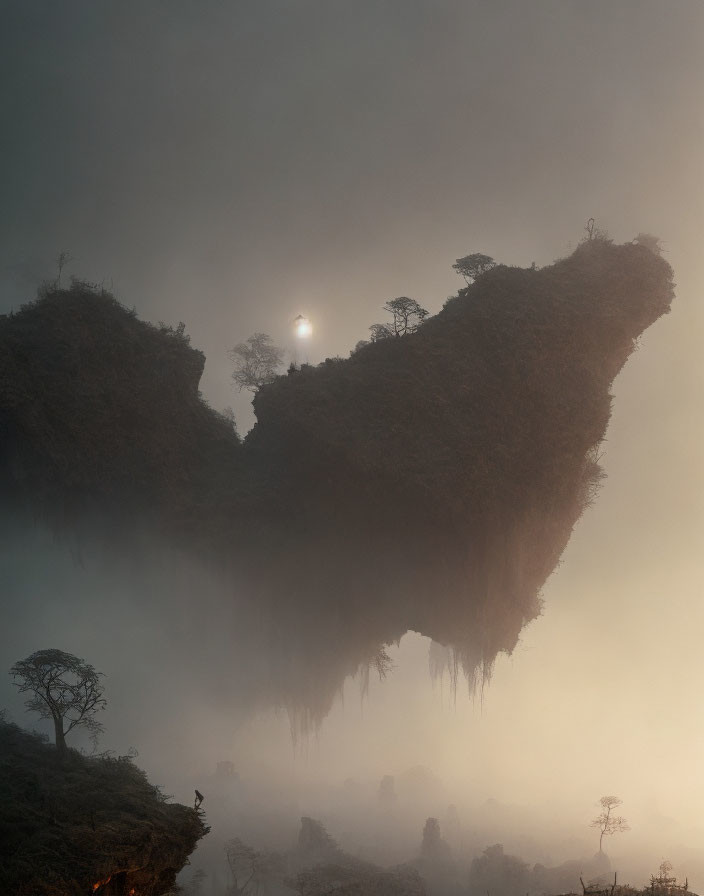 Misty landscape with sun peeking through fog on elevated landmass