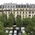 Urban garden painting with greenery, building, and boats