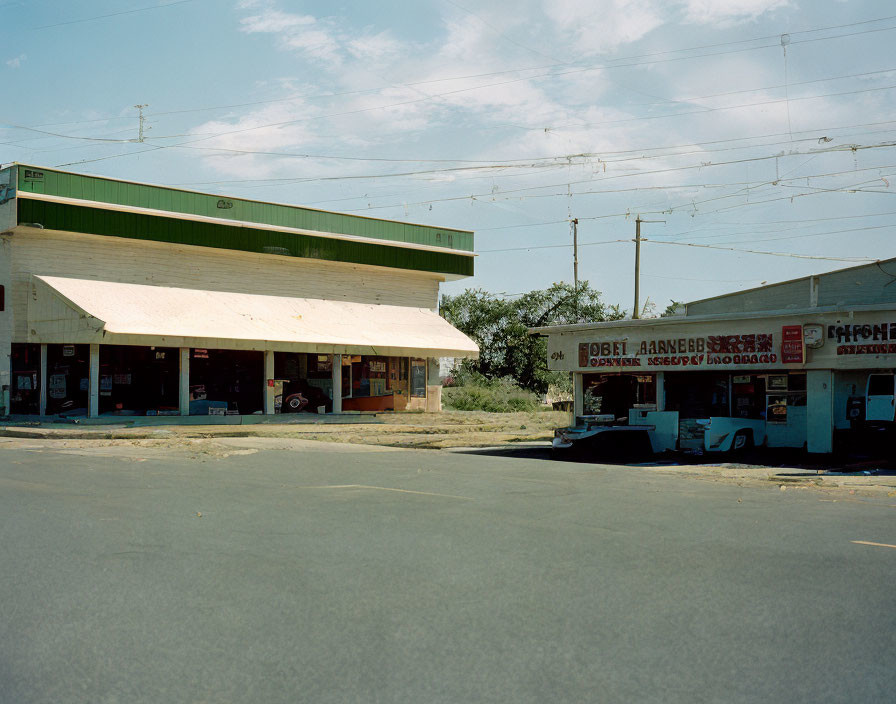 Old-fashioned one-story buildings with signs on quiet street view