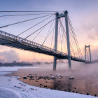 Suspension bridge over misty waters with aurora lights and snow-covered lands