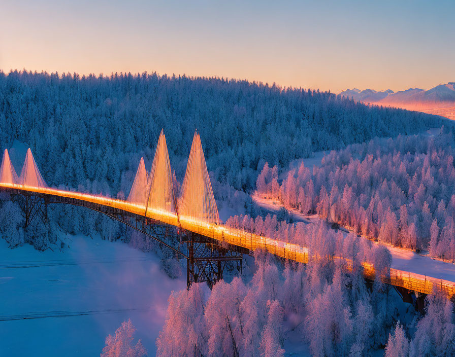 Snow-covered landscape with lit bridge over frozen river at dusk