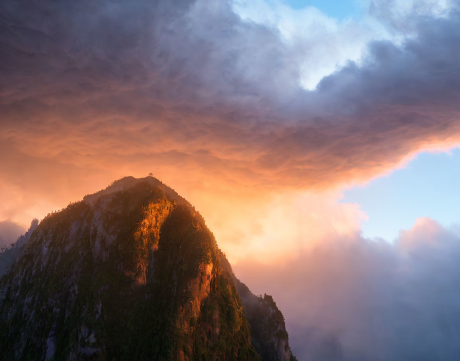 Majestic mountain peak under dramatic orange sky