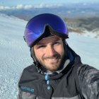 Man in ski goggles and jacket in snowy landscape