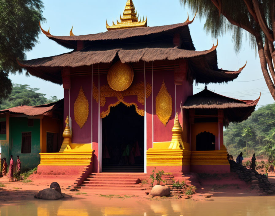 Traditional Myanmar Temple with Tiered Roof and Gold Patterns Amid Lush Greenery