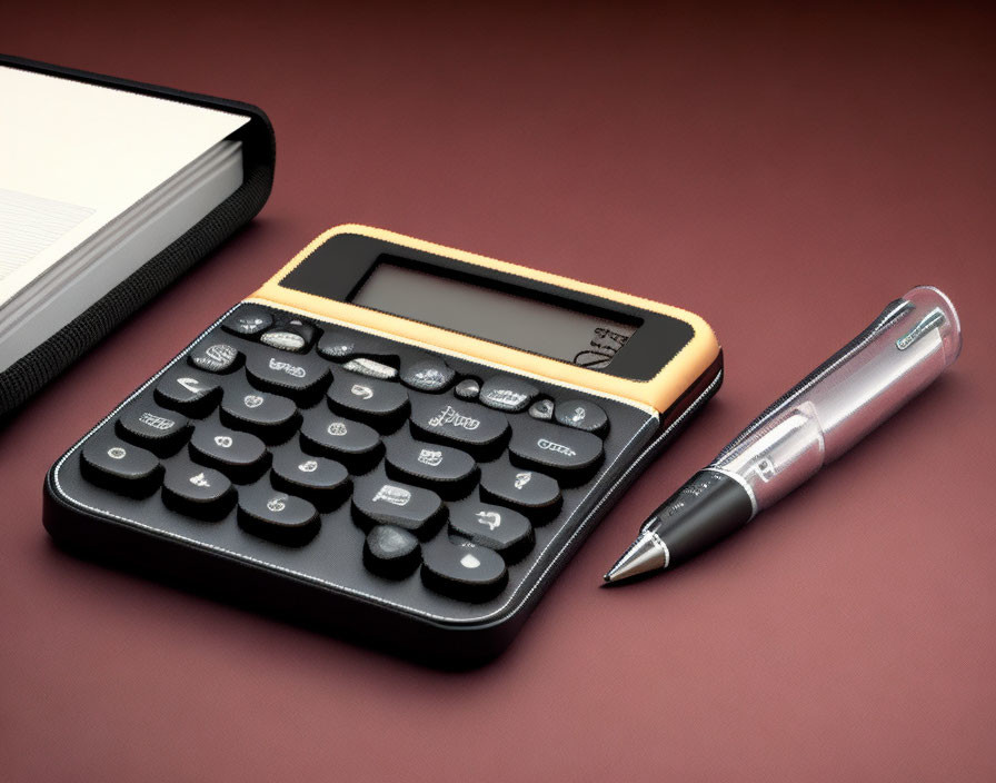 Desk setup with e-reader, calculator, and pen