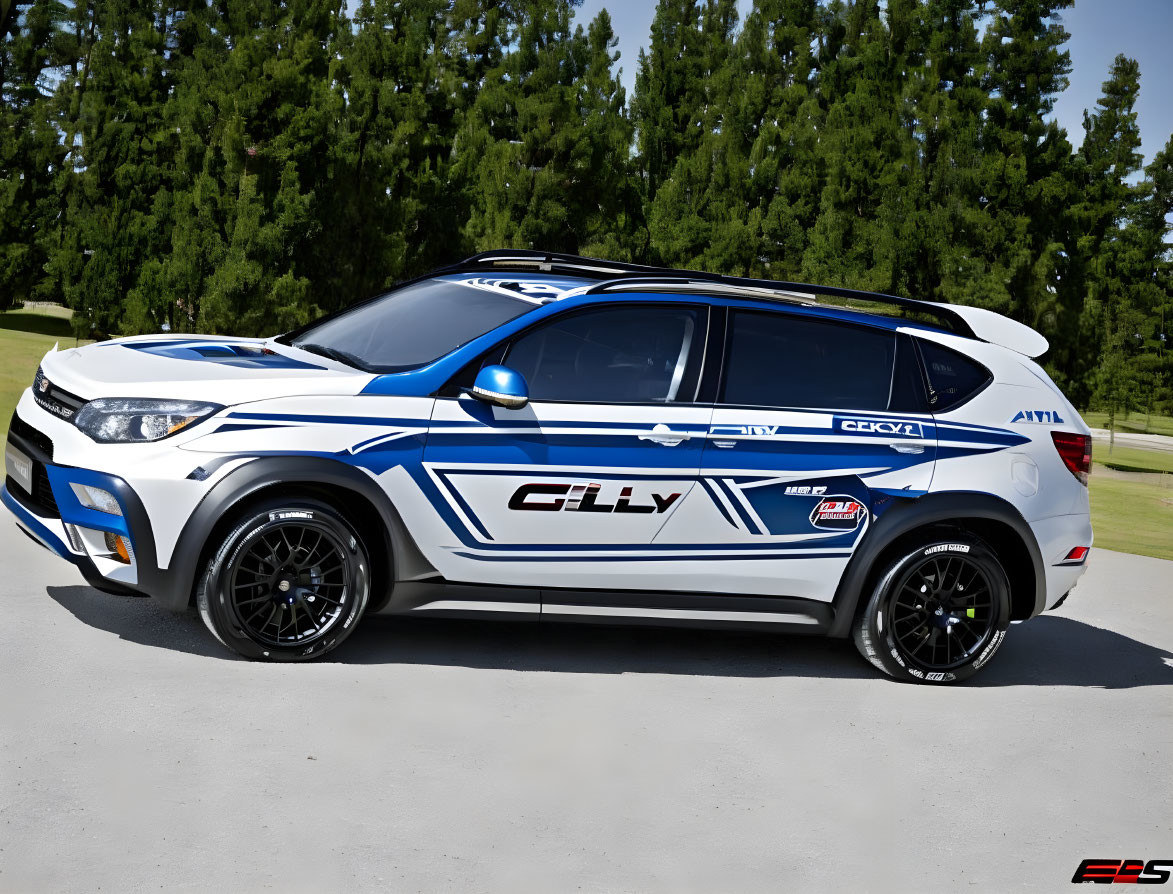 White SUV with blue and black decals and aftermarket wheels parked on grassy area