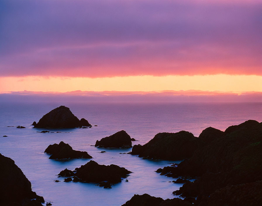 Tranquil Coastal Seascape at Dusk with Purple and Orange Sky